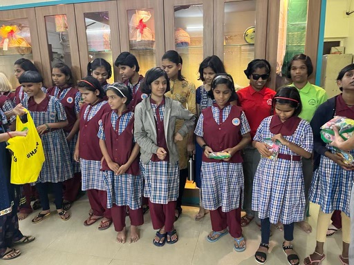 Girls at the orphanage holding the candy CandyForKids shared in 2024